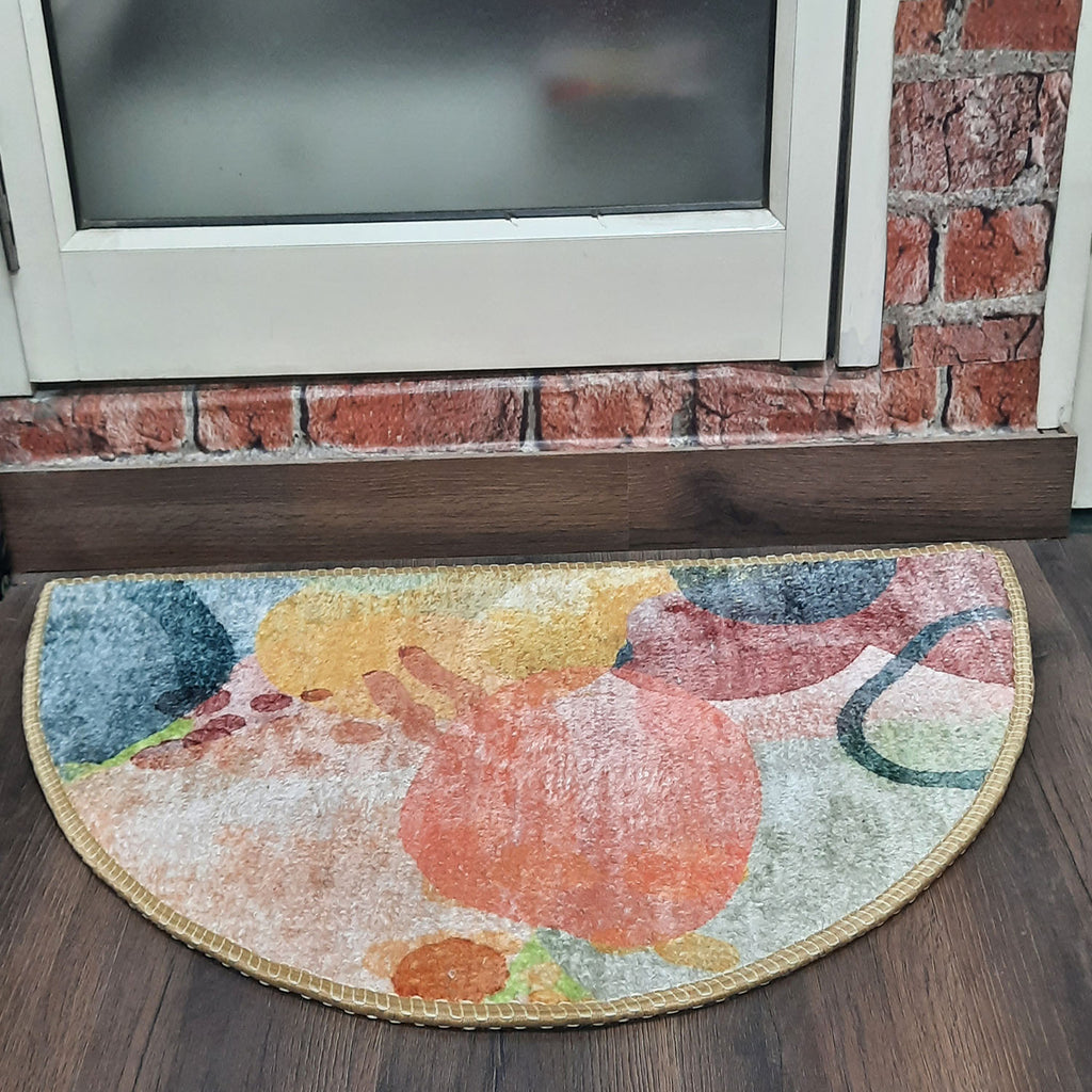 Semi-circular indoor door mat with bold geometric patterns and rich colors.