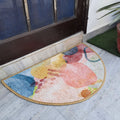 Colorful semi-round geometric rug placed at a stylish home doorway.