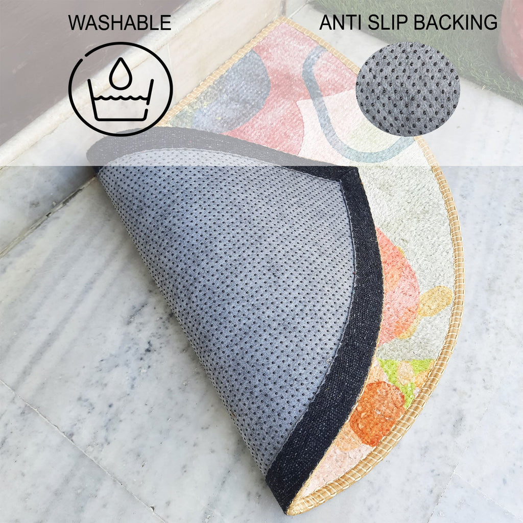 Decorative half-circle welcome rug resting on polished marble flooring.