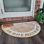 Semi-round welcome mat designed with colorful geometric artwork.