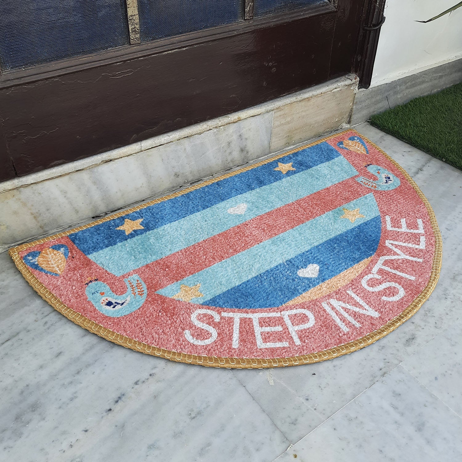Bright geometric semi-round door mat adding color to a welcoming doorway.