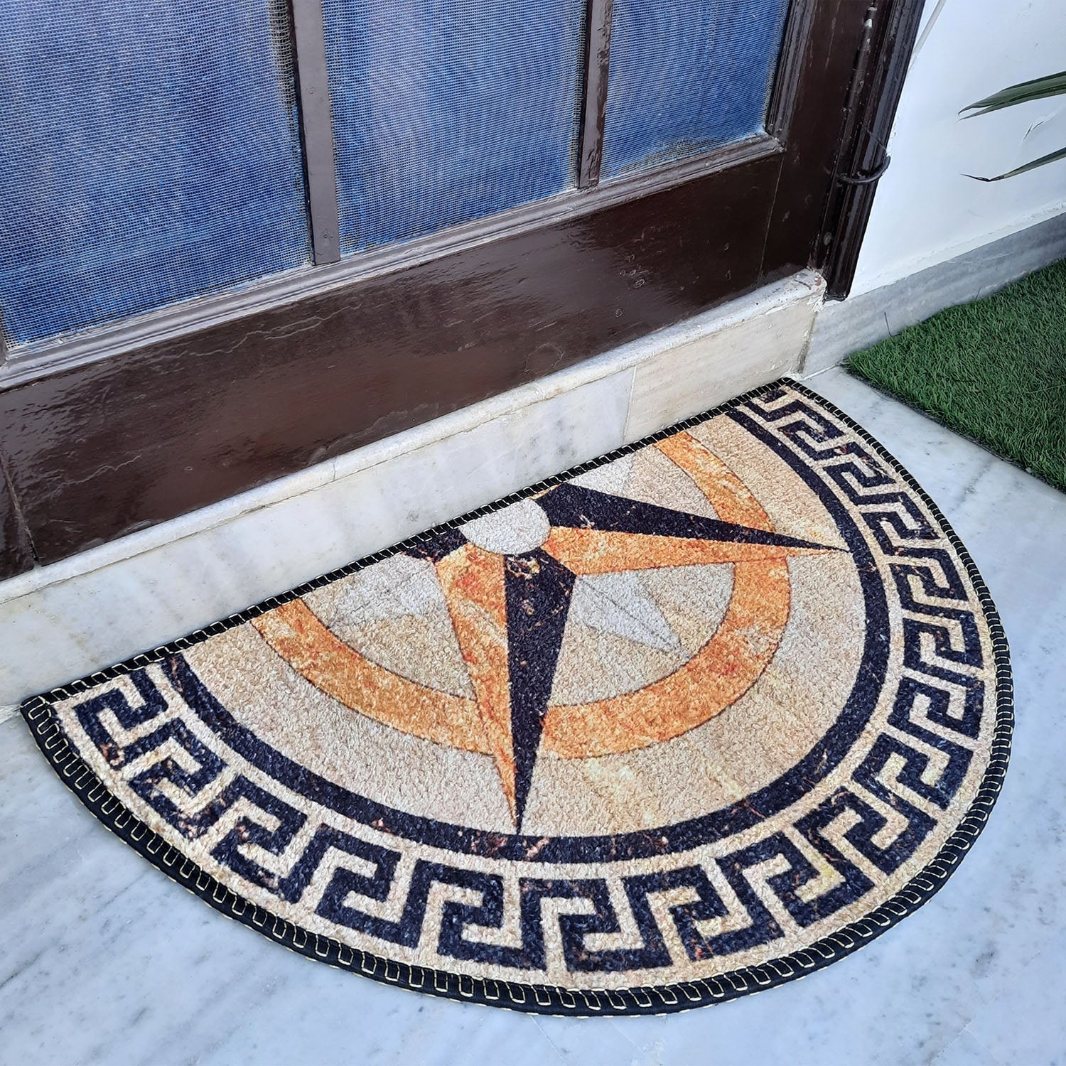 Boho-inspired semi-circle entrance mat featuring intricate geometric motifs.