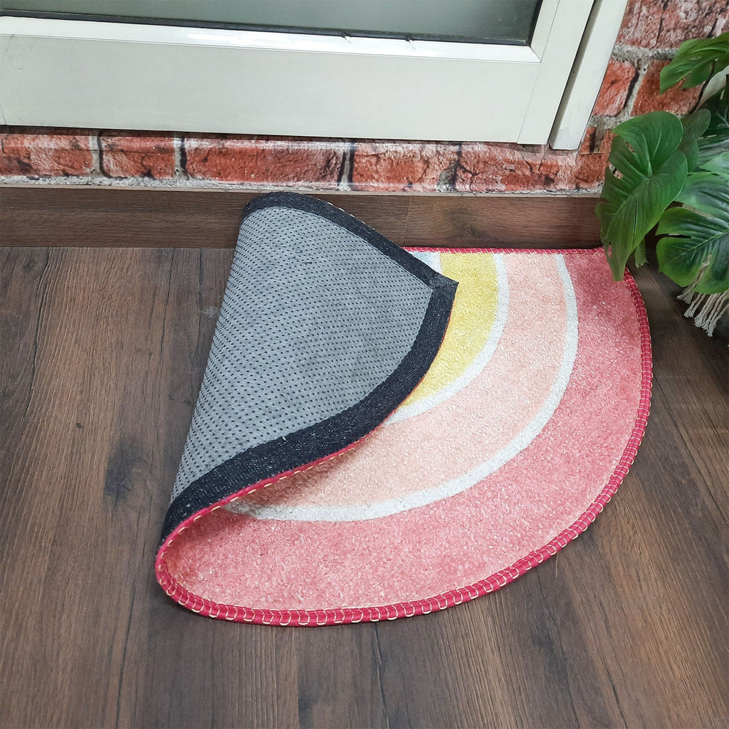 Decorative semi-circular rug placed at the home's front doorway.