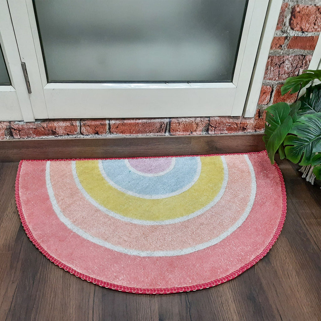 Half-round floor mat with artistic geometric print for entryways.