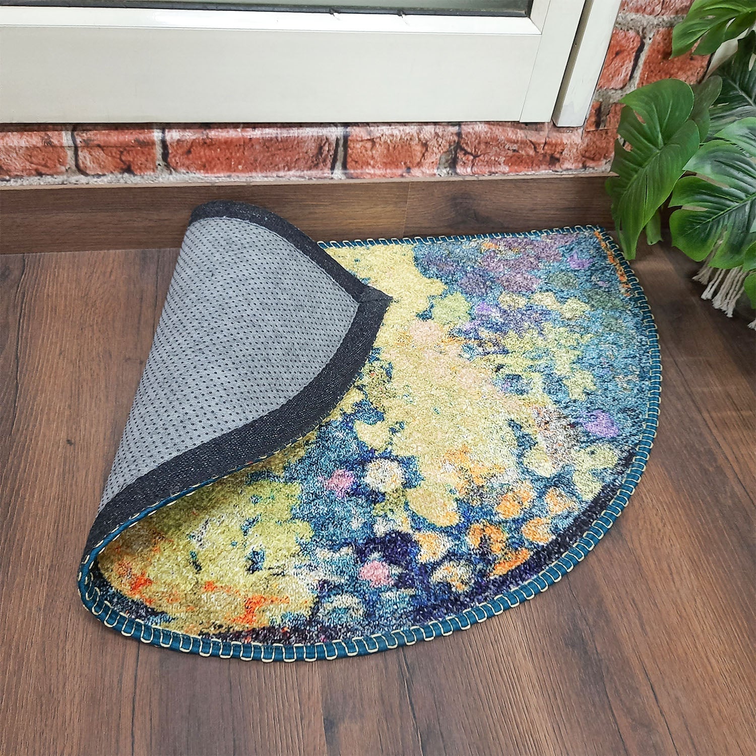 Artistic semi-circular floor mat featuring bold geometric shapes.