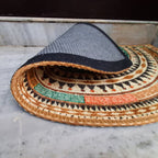 Semi-circular decorative mat with symmetrical geometric design.
